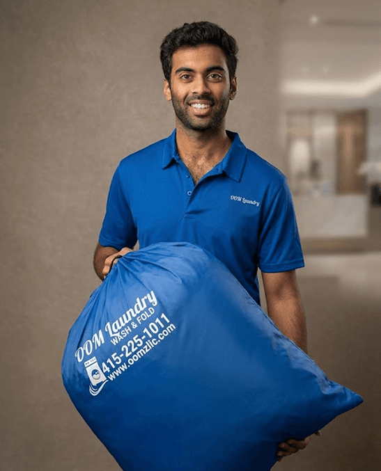 Oomz team member holding a laundry bag